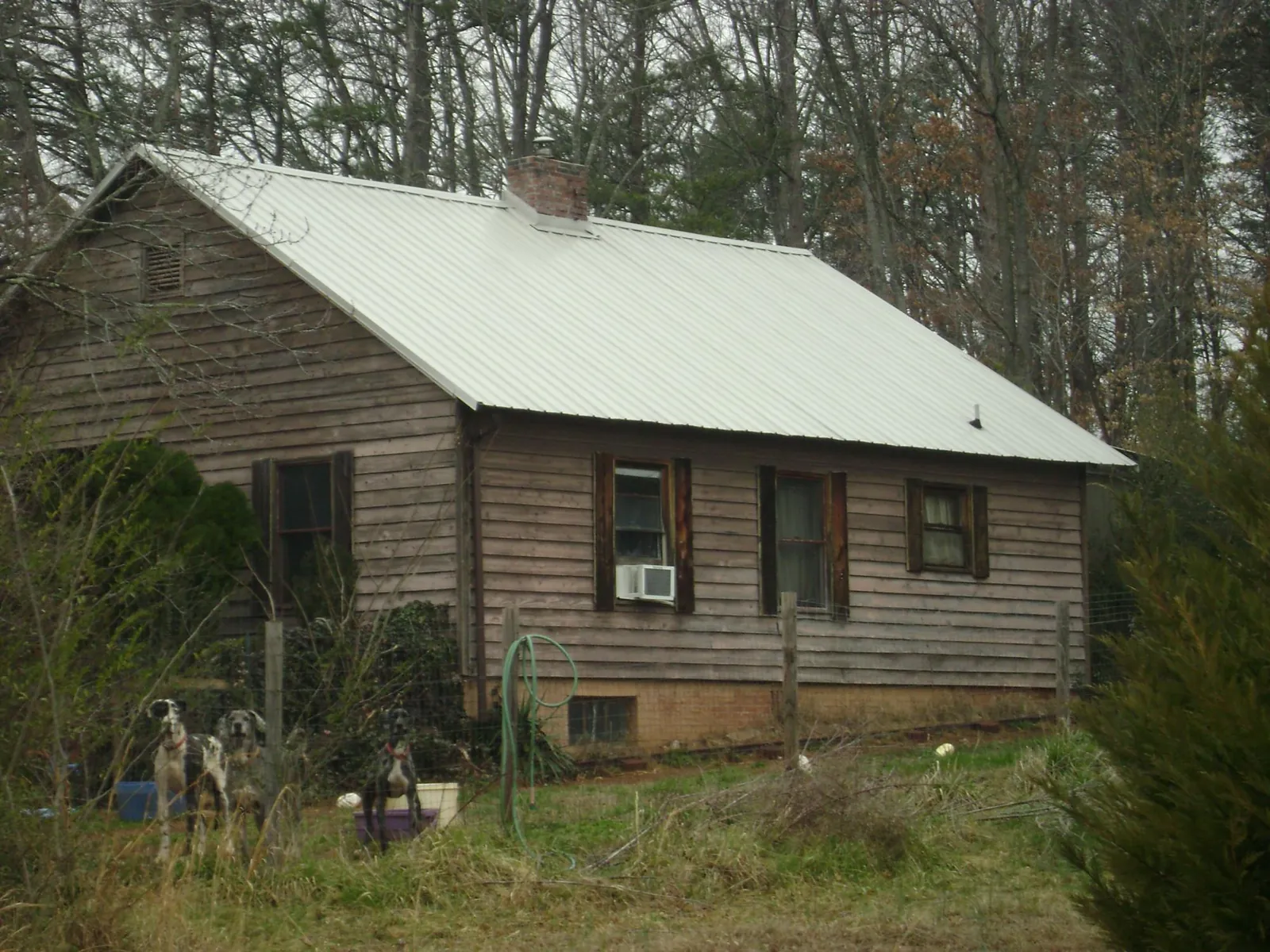 White metal roof on an old wood sided farmhouse, from a Metal Roof Installation job in South Bound Brook